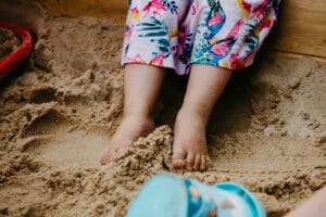 Mädchenfüsse im Sandkasten
